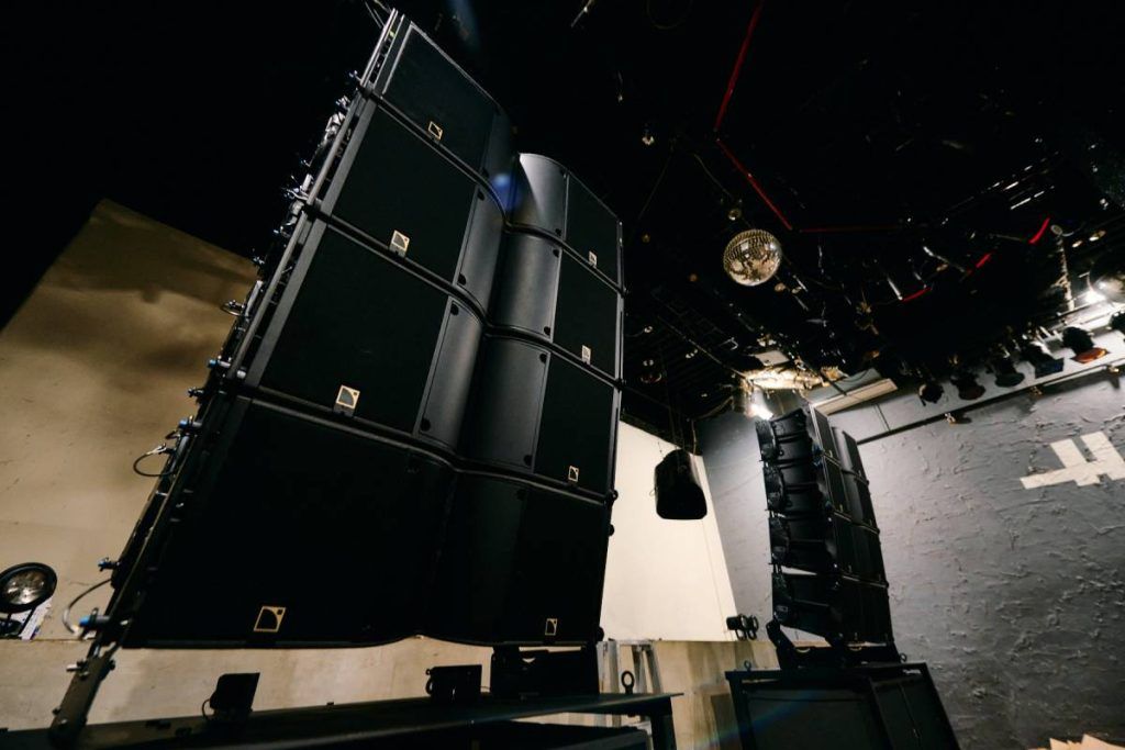 Two stacks of four L-Acoustics K3 on top of two KS28 subwoofers in front of the HARLEM DJ booth.