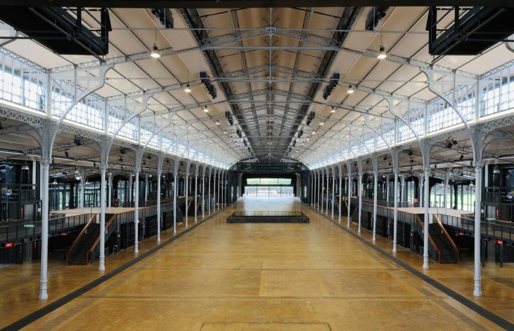 Grande Halle de la Villette has a distinctive 19th-century industrial architecture featuring soaring glass and intricate cast iron framework