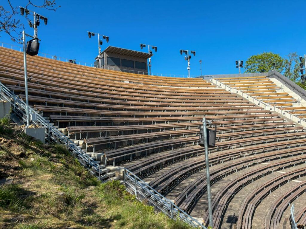 Fourteen L-Acoustics X12 speakers are strategically positioned around the tiered seating area to provide comprehensive coverage throughout the entire seating area