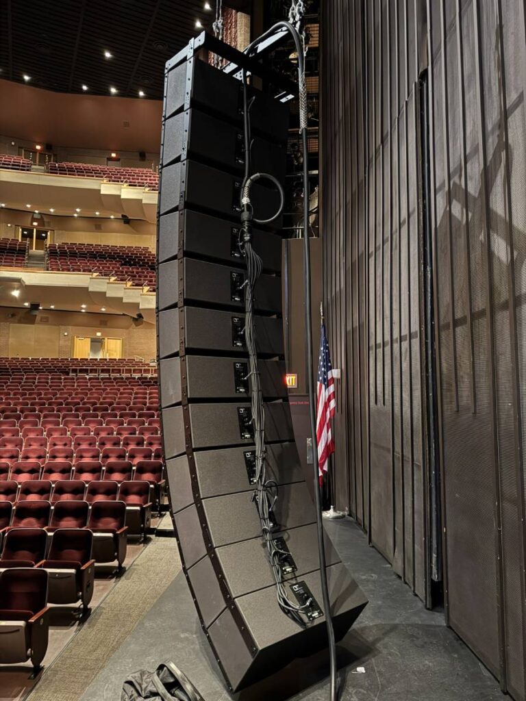 The venue’s house-left L-Acoustics K3i array ready for rigging