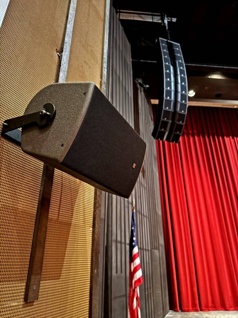 A close-up of one of the hall’s L-Acoustics X8 surround-fill speakers with a K3i array seen in the background