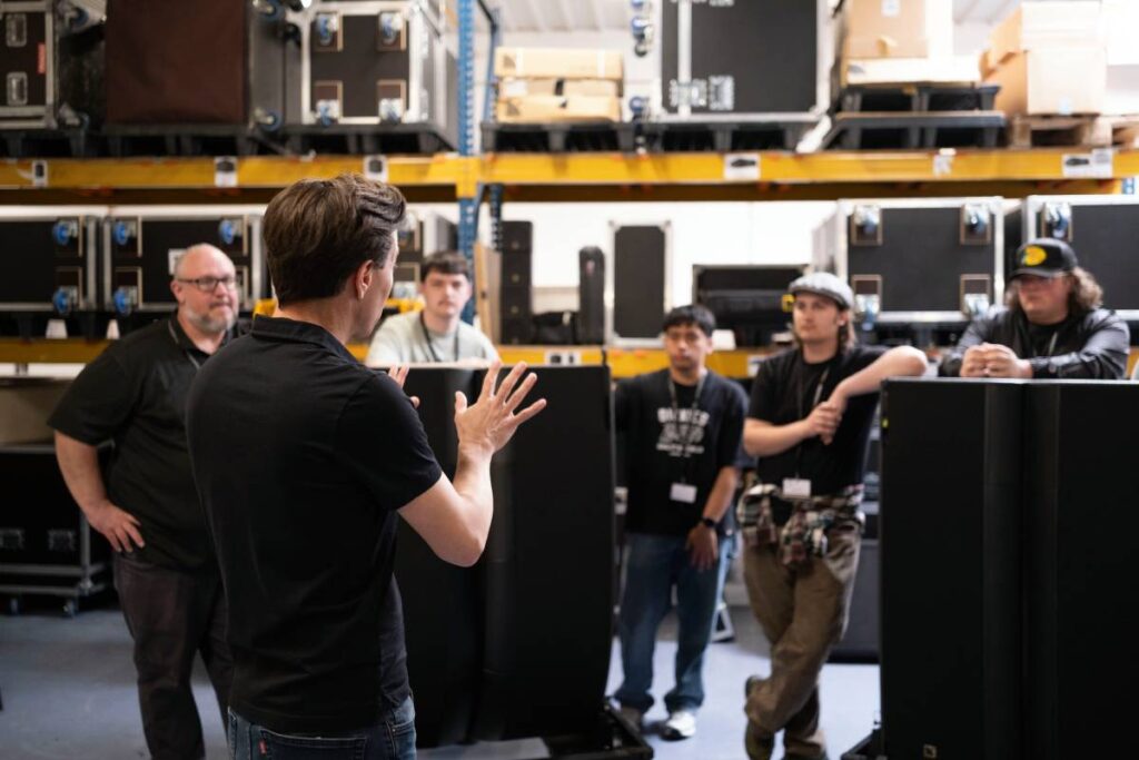 Belmont University students learning rigging techniques during a visit to L-Acoustics in Marcoussis, France