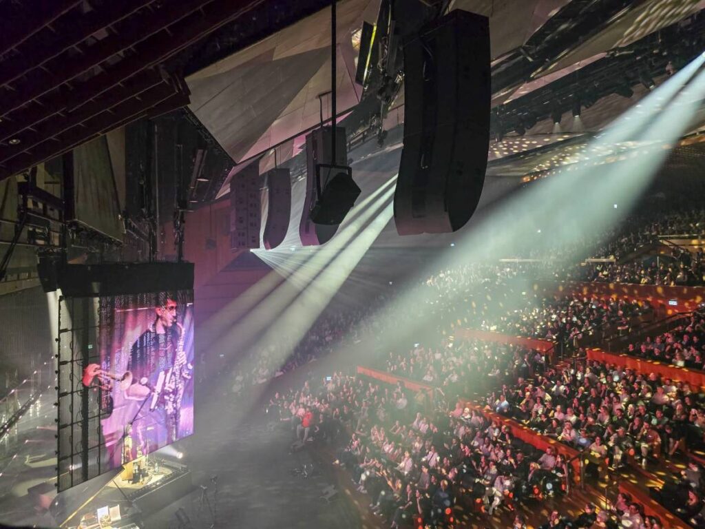 The final configuration features five hangs of one L2 over an L2D, two extension hangs of four A10 clusters on each side and a centre-hung array of six KS28 in cardioid mode, all integrated into the ceiling structure 