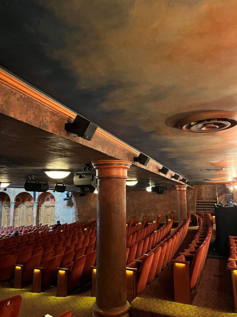 A line of ultra-compact L-Acoustics 5XT coaxials supply delay coverage to the rear orchestra-level seating area