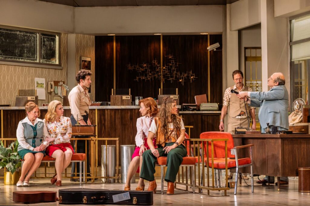 A scene from Dog Day Afternoon featuring Wilemina Olivia-Garcia (“Lorna”), Andrea Syglowski (“Alison”), Jon Bernthal (“Sonny”), Elizabeth Canavan (“Roxxanna/Gloria”), Paola Lázaro (“Guadalupe”), Ebon Moss-Bachrach (“Sal”), and Michael Kostroff (“Butterman”) – photo credit: Evan Zimmerman