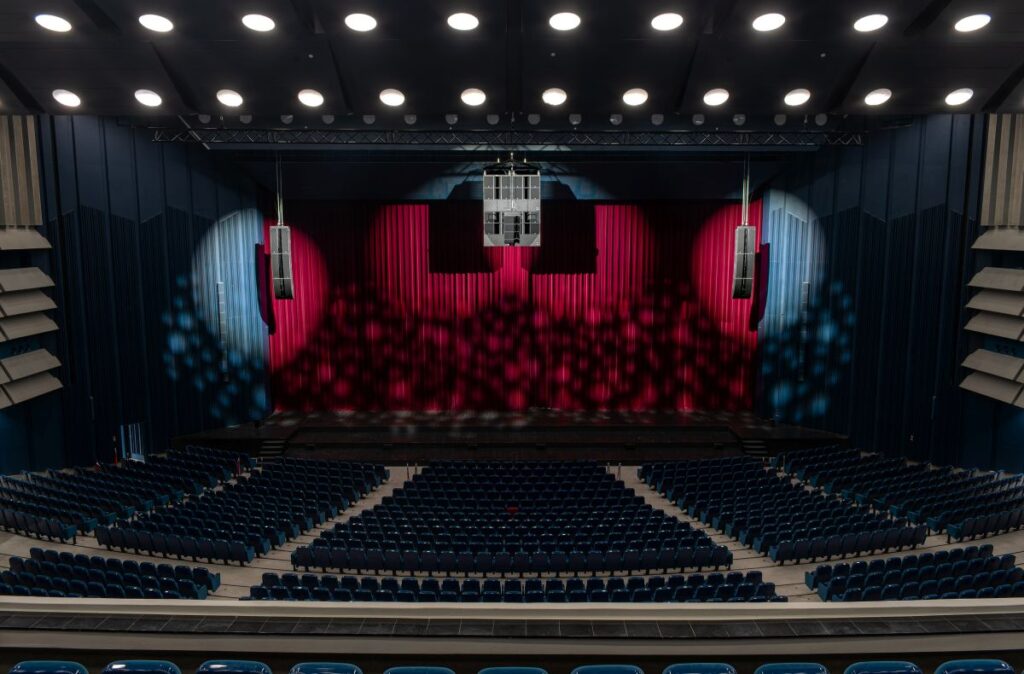 The L-Acoustics system design navigates extreme visual constraints and a room built for a different era of production