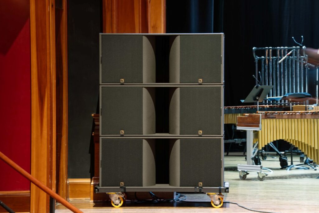 Three KS28 subs are stacked on the stage below each K3i array