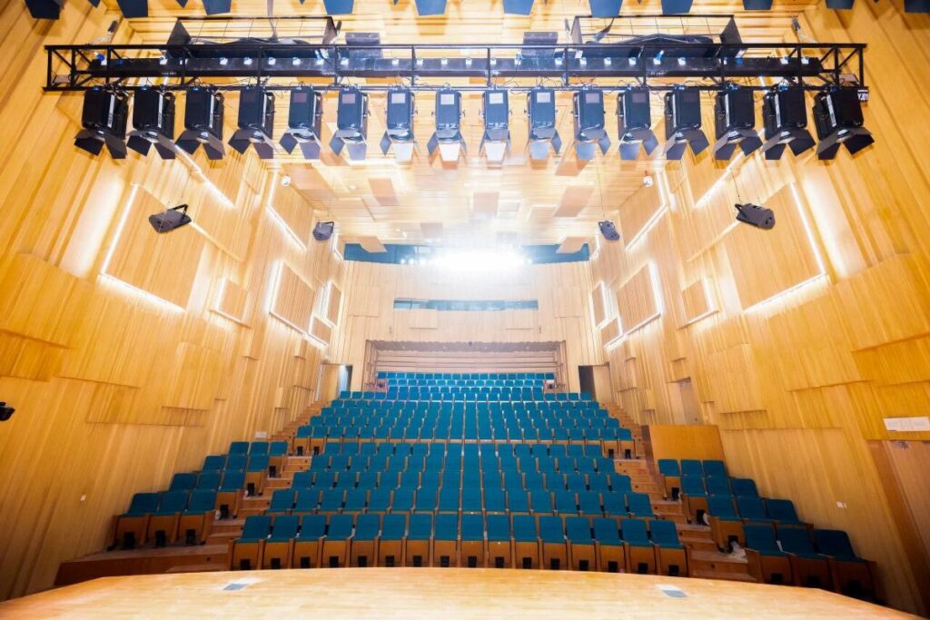 Racpro paired the installation with full system training and a set of scene presets, so staff can recall a configuration for a recital or a lecture rather than build one from scratch