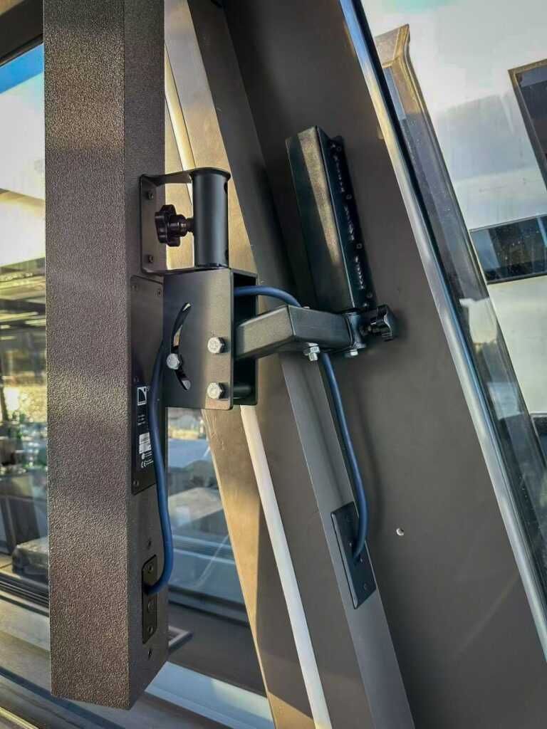 L-Acoustics Soka's slim, upright profile sits flush against the boat's window frames, holding sightlines and the minimalist interior intact rather than competing with them