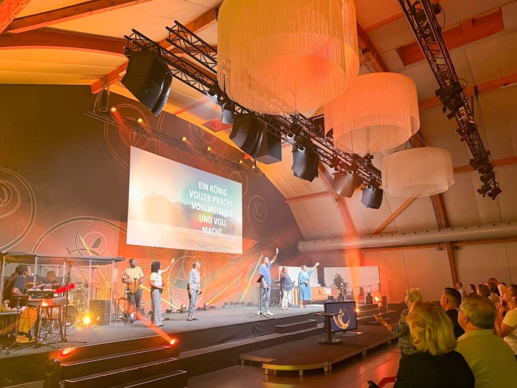 Swiss partners SDS, Soundrig AG, Stagelight and Impact Atelier thread a five-hang A15i system around a fabric dome, a landmark chandelier and front projection, turning a like-for-like replacement into an immersive church sound system