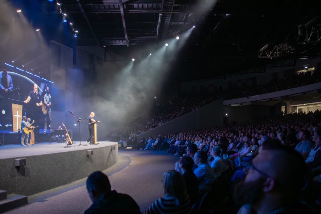 The new auditorium nearly doubles the capacity of the church’s previous 3,000-seat home and adds a balcony